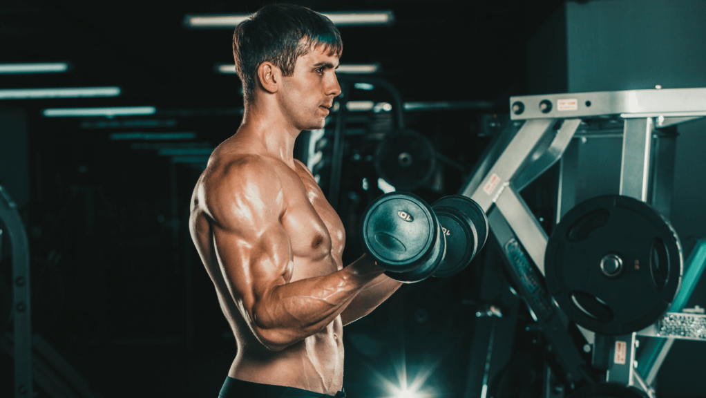 Man focused on his bicep curls, embodying the mind-muscle connection.